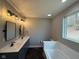Elegant bathroom with double vanity, free-standing tub, and a window at 3380 N Pine Song Dr, Martinsville, IN 46151