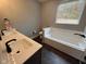 Bathroom boasts double vanity, soaking tub, and dark tile flooring at 3380 N Pine Song Dr, Martinsville, IN 46151