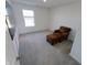 Bedroom with brown chair and ottoman, wall-mounted TV and grey carpeting at 996 Bent Branch Ln, Greenwood, IN 46143