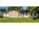 Tan brick ranch house with black shutters and a green lawn at 3536 N Audubon Rd, Indianapolis, IN 46218