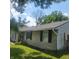 Tan brick ranch house with black shutters and a green lawn at 3536 N Audubon Rd, Indianapolis, IN 46218