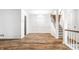 Bright dining room, hardwood floors, and adjacent staircase at 571 Lockerbie S Cir, Indianapolis, IN 46202