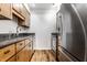Small kitchen with wood cabinets and granite countertops at 571 Lockerbie S Cir, Indianapolis, IN 46202