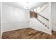 Spacious dining area with hardwood floors and a staircase at 571 Lockerbie S Cir, Indianapolis, IN 46202
