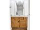 Bathroom with wood vanity and large mirror at 571 Lockerbie S Cir, Indianapolis, IN 46202