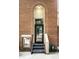 Brick entryway with a black door and metal stairs at 571 Lockerbie S Cir, Indianapolis, IN 46202