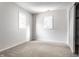Bright bedroom with neutral walls and carpet, featuring two windows and a closet at 571 Lockerbie S Cir, Indianapolis, IN 46202