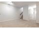 Spacious basement with neutral walls, carpet, and a staircase at 571 Lockerbie S Cir, Indianapolis, IN 46202