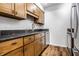 Modern kitchen with stainless steel appliances and wood cabinets at 571 Lockerbie S Cir, Indianapolis, IN 46202