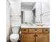 Bathroom with shower, toilet, and wood vanity at 571 Lockerbie S Cir, Indianapolis, IN 46202