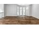 Sunlit living room with bay window and hardwood floors at 571 Lockerbie S Cir, Indianapolis, IN 46202