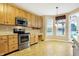 Kitchen with stainless steel appliances and ample wood cabinets at 201 Creekview Cir, Mooresville, IN 46158