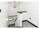 Modern staircase with black accents and gray flooring, leading to the upper level at 2435 Columbia Ave, Indianapolis, IN 46205