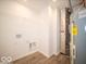 Laundry room with built-in shelving and vinyl flooring at 6289 Rhinecliff Dr, Whitestown, IN 46075