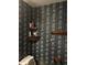 Small bathroom with floral wallpaper and a wooden shelf at 9145 Shenandoah Dr, Indianapolis, IN 46229