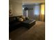 Living room with sectional sofa, ottoman, and floor-to-ceiling curtains at 9145 Shenandoah Dr, Indianapolis, IN 46229
