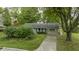 Ranch home with a paved driveway and mature landscaping at 451 Emerson Rd, Carmel, IN 46032
