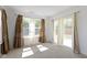 Living room with large windows and patio access at 10125 Caprock Canyon Dr, Indianapolis, IN 46229