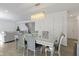 Open concept dining room with a modern chandelier and seating for six at 10125 Caprock Canyon Dr, Indianapolis, IN 46229
