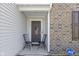 Inviting front porch with two black chairs and American flag at 10125 Caprock Canyon Dr, Indianapolis, IN 46229