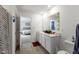 Clean bathroom with double vanity and access to bedroom at 10125 Caprock Canyon Dr, Indianapolis, IN 46229