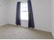 Well-lit bedroom featuring a large window and carpet flooring at 10125 Caprock Canyon Dr, Indianapolis, IN 46229