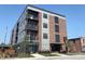 Modern apartment building with brick and gray siding, multiple balconies at 150 S Main St # 202, Franklin, IN 46131