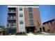 Brick building with multiple levels, balconies, and ground-level commercial space at 150 S Main St # 202, Franklin, IN 46131