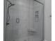 Sleek walk-in shower with gray tile, glass enclosure, and built-in seat at 150 S Main St # 202, Franklin, IN 46131