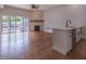 Spacious living area with hardwood floors, stone fireplace, and kitchen island view at 150 S Main St # 202, Franklin, IN 46131