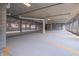 Underground parking garage with concrete floors and designated parking spaces at 150 S Main St # 202, Franklin, IN 46131