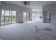 Spacious living room with large windows, a ceiling fan, and access to a balcony at 150 S Main St # 202, Franklin, IN 46131