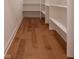Bright pantry with ample shelving and hardwood flooring at 150 S Main St # 302, Franklin, IN 46131