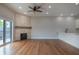 Open living room featuring hardwood floors, a stone fireplace, and access to a balcony at 150 S Main St # 302, Franklin, IN 46131