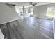 Spacious living area showcasing gray vinyl plank flooring and kitchen views at 6558 Caressa Way, Indianapolis, IN 46259