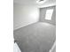 Spacious bedroom with gray carpeting and a large window at 6558 Caressa Way, Indianapolis, IN 46259