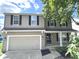 Two story house with neutral exterior and a double garage at 6558 Caressa Way, Indianapolis, IN 46259