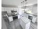 Island kitchen with white cabinets, granite countertops and stainless steel appliances at 6558 Caressa Way, Indianapolis, IN 46259
