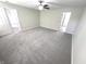 Spacious bedroom with grey carpet and ceiling fan at 6558 Caressa Way, Indianapolis, IN 46259