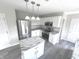 Modern kitchen with white cabinets, granite countertops, and stainless steel appliances at 6558 Caressa Way, Indianapolis, IN 46259