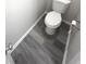 Clean and simple half bathroom with gray vinyl flooring at 6558 Caressa Way, Indianapolis, IN 46259