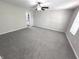 Bright bedroom featuring grey carpet and ceiling fan at 6558 Caressa Way, Indianapolis, IN 46259