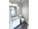 Modern half bathroom with granite countertop and white cabinets at 6558 Caressa Way, Indianapolis, IN 46259