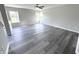 Open living room with gray vinyl plank flooring and access to kitchen at 6558 Caressa Way, Indianapolis, IN 46259