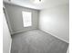 Spacious bedroom with gray carpet, a closet, and large window at 6558 Caressa Way, Indianapolis, IN 46259