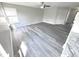 Spacious living room featuring gray vinyl plank flooring and ceiling fan at 6558 Caressa Way, Indianapolis, IN 46259