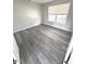 Bright bedroom with gray vinyl plank flooring and large window at 6558 Caressa Way, Indianapolis, IN 46259