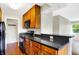 Modern kitchen with wood cabinets and black appliances at 3965 N Meridian St # 3B, Indianapolis, IN 46208