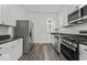 Modern kitchen with stainless steel appliances and white cabinets at 248 N Walcott N St, Indianapolis, IN 46201