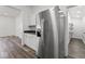 Stainless steel refrigerator in kitchen with white cabinets and granite countertops at 248 N Walcott N St, Indianapolis, IN 46201